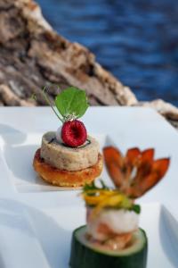 a plate of food with a strawberry on top of it at The Residence Zanzibar in Kizimkazi