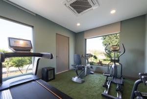 a gym with a treadmill and ellipticals in a room at WelcomHeritage Cheetahgarh Resort & Spa in Bera
