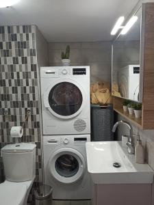 bagno con lavatrice e lavandino di Kallias Modern Seaview Apartment a Heraklion