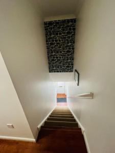a staircase with a brick wall and a stair case at Lovely entire 2 Bedroom apartment in Monifieth