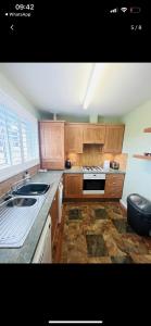 a kitchen with a sink and a stove top oven at Lovely entire 2 Bedroom apartment in Monifieth