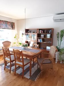 a dining room with a wooden table and chairs at Dals Långeds B&B in Dals Långed