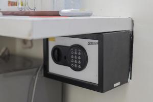 a microwave oven hanging on a counter at RedDoorz Plus At K23 Rungkut Madya in Surabaya