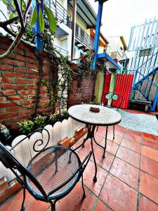 a table and chairs sitting on a patio at Tongzhuang B&B 依人數開放房型 in Tainan