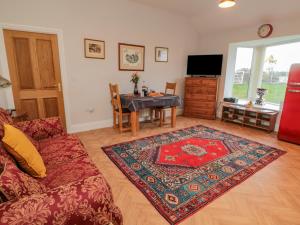 a living room with a couch and a table at High Barns Cottage in Morpeth