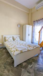 a large white bed in a room with a window at GreenCity Kavala in Kavála