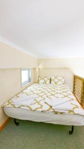 a large white bed in a room with a window at GreenCity Kavala in Kavala