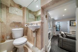 a bathroom with a toilet and a sink at Finest Retreats - Hampsted Studio in London