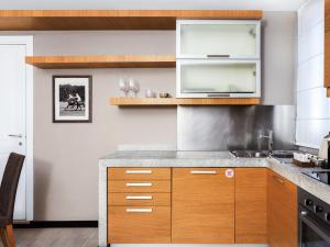 a kitchen with wooden cabinets and a counter top at numa I Vici Rooms & Apartments in Rome