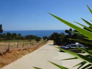 a sidewalk with cars parked on the side of a road at Camping Mozziconaccio in Sainte-Lucie de Porto-Vecchio