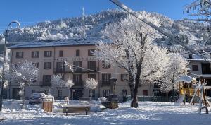 a building with a ski lift in the snow at Hotel Sommeiller in Bardonecchia