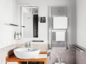 a bathroom with a white sink and a mirror at numa I Vici Rooms & Apartments in Rome