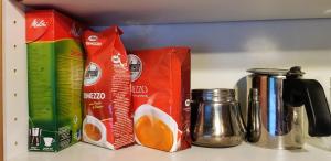 a shelf with juice boxes and coffee makers on a counter at Apartment Schönblick in Verditz