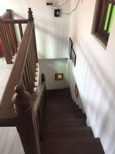 a stairway in a house with a wooden staircase at Sweet Pea Homestay in Balapitiya