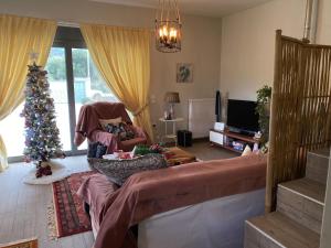 a living room with a christmas tree and a living room with a christmas at Stellas guesthouse near Arachova in Stírion