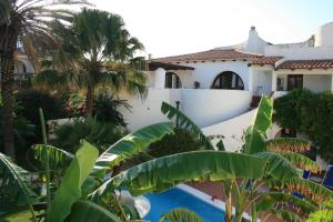a view from the garden of a house with a swimming pool at Hotel Villa Mediterranea in Noto Marina
