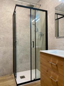 a glass shower in a bathroom with a sink at Cervinia Ski In Ski Out - Family Studio in Breuil-Cervinia