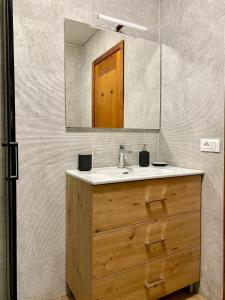 a bathroom with a sink and a mirror at Cervinia Ski In Ski Out - Family Studio in Breuil-Cervinia +11 photos