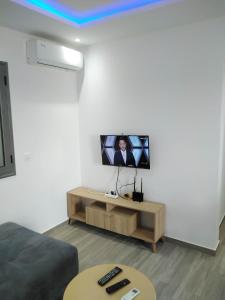 a living room with a flat screen tv on a wall at Résidence Inès Djerba Appartement de Luxe in Houmt Souk