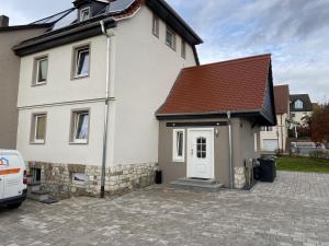 a white house with a brown roof at WA110 - Große Monteurunterkunft in Wackersdorf in Wackersdorf