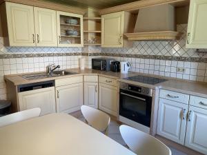 a kitchen with white cabinets and a sink and a stove at WA110 - Große Monteurunterkunft in Wackersdorf in Wackersdorf