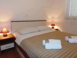 a bedroom with a large bed with two white towels at Apartment in Dramalj with sea view, balcony, air conditioning, WiFi 4623-3 in Dramalj +33 photos