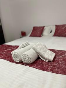two towels are sitting on top of a bed at BUTTERFLY FAMILY APARTMENT SIBIU in Sibiu