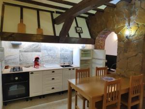 a kitchen with a table and a dining room at Casa Rústica in Finestrat