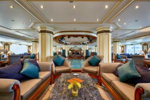 a living room with couches and a table at Sonesta St George Nile Cruise - Aswan to Luxor 3 Nights from Friday to Monday in Aswan