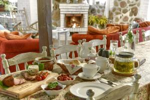 a table with food on it with a table cloth at Agroturystyka nad jeziorem Sopień in Brzozie