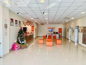 a christmas tree in the middle of a hospital lobby at JOIN INN HOTEL Jebel Ali, Dubai - Formerly easyHotel Jebel Ali in Dubai