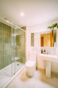 a bathroom with a toilet and a shower and a sink at The Old Tea Factory in London