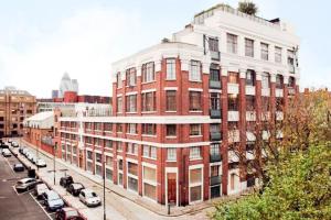 a large red brick building on a city street at The Old Tea Factory in London