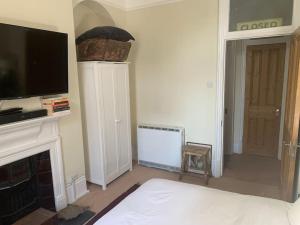 a living room with a flat screen tv and a fireplace at Central London (West End) two bedroom flat in London