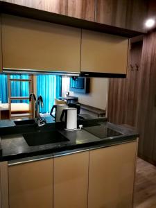 a kitchen with a sink and a counter top at Luxury Hotel Suite Apartment in Batumi