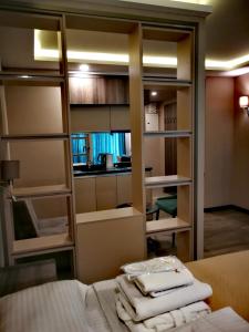 a room with a bed and a room with shelves at Luxury Hotel Suite Apartment in Batumi