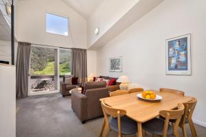 a living room with a table and a couch at Squatters Run Unit 11 in Thredbo