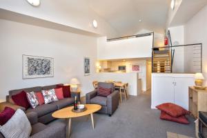 a living room with a couch and a table at Squatters Run Unit 11 in Thredbo +6 photos