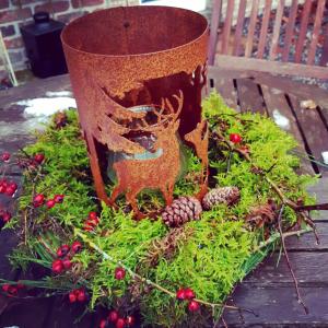 a planter with a reindeer on top of plants at La Maison des Senteurs in Francorchamps