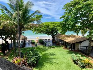 a resort with a view of the beach at Pousada Solar dos Girassóis in Bombinhas