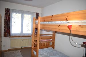 a bedroom with two bunk beds and a window at Ursina (301 Sh) in Sporz