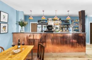 a restaurant with a wooden bar with a wooden table at The Swan Inn Letton in Letton