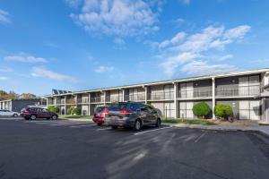 a parking lot with cars parked in front of a building at Quality Inn in Rock Hill