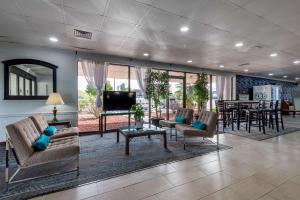 a living room with chairs and a tv and a table at Quality Inn in Rock Hill