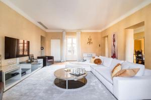 a living room with a white couch and a table at Santa Giuliana Apartment in Como