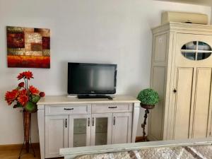 a tv sitting on top of a cabinet in a room at Supreme appartment in Balchik