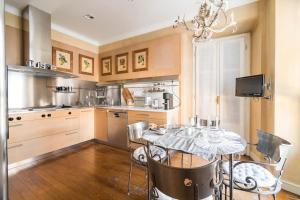 a kitchen with a table and chairs in a room at Santa Giuliana Apartment in Como