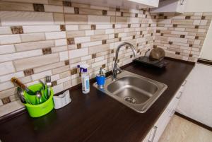 a kitchen counter with a sink in a kitchen at Bonus in Vinnytsya +84 photos