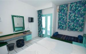 a room with a bed and a mirror and a window at LE KHALIFE in Hammamet