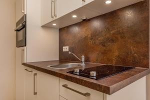 a kitchen with a sink and a counter top at Villa Quisisana in Binz +99 photos